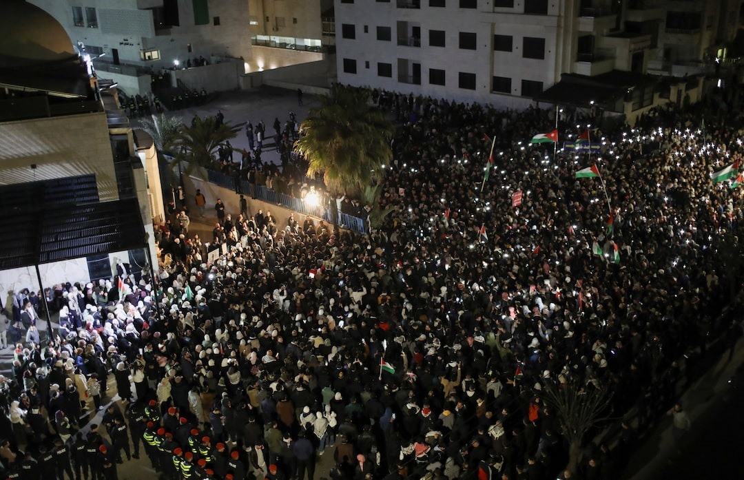 Jordanian anti-riot police use batons to push back protesters near Israeli embassy